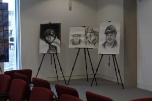 Pencil drawings of miners on easels